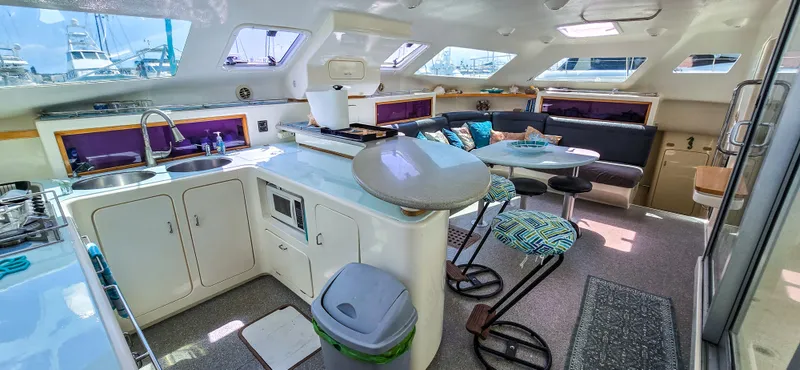 Makai Yacht Photos Pics Spacious interior of 1997 Voyage Mayotte 50 catamaran with modern kitchen and seating area.