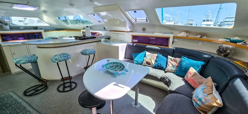 Makai Yacht Photos Pics Luxurious interior of 1997 Voyage Mayotte 50 yacht with modern kitchen and cozy seating area.