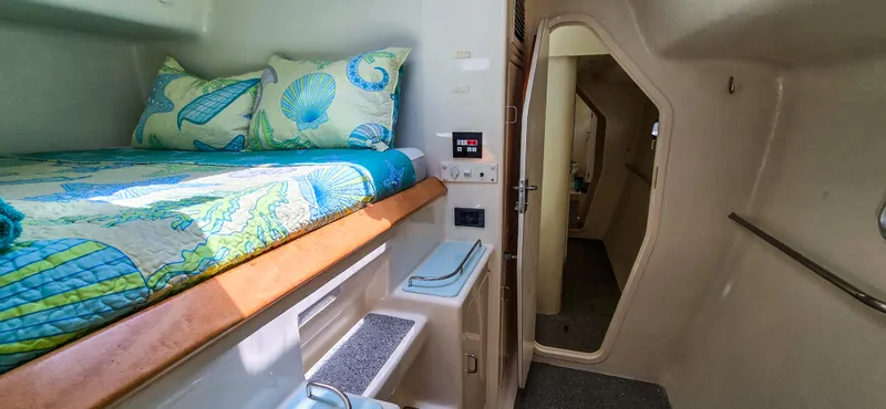 Makai Yacht Photos Pics Cozy cabin interior of 1997 Voyage Mayotte 50 catamaran with colorful bedding.