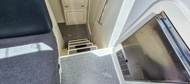 Makai Yacht Photos Pics Interior stairs of 1997 Voyage Mayotte 50 yacht, featuring carpeted steps and sleek design.