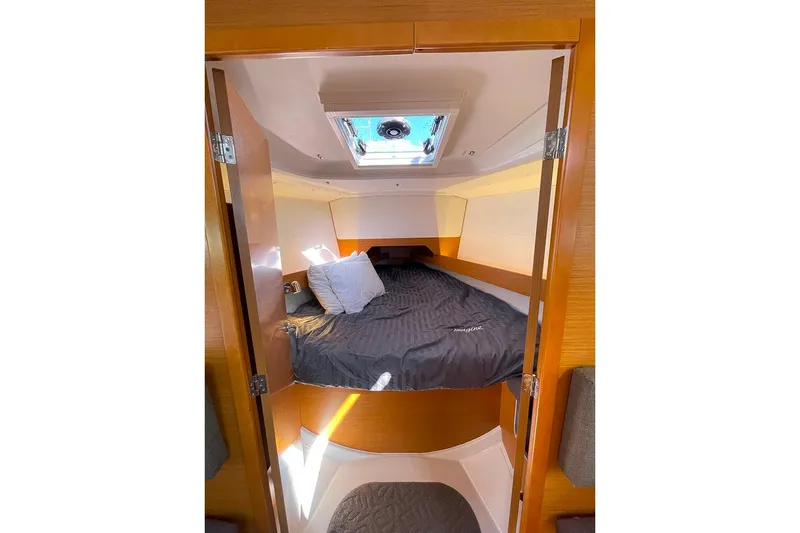 Imagine Yacht Photos Pics Cozy cabin interior of 2017 Jeanneau Sun Odyssey 349 sailboat with skylight and bedding.