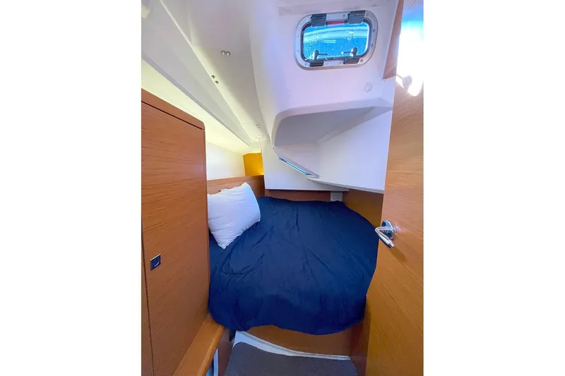 Imagine Yacht Photos Pics Cozy cabin interior of 2017 Jeanneau Sun Odyssey 349 sailboat with bed and porthole.