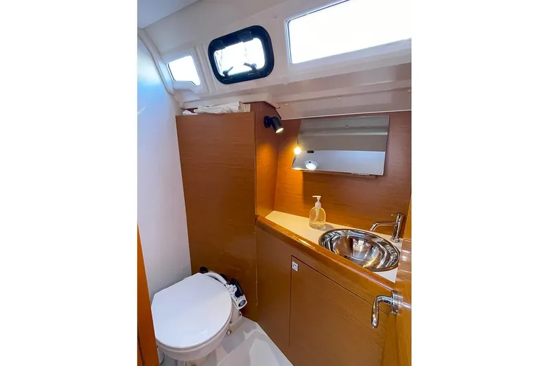 Imagine Yacht Photos Pics 2017 Jeanneau Sun Odyssey 349 bathroom with sink, mirror, and toilet.