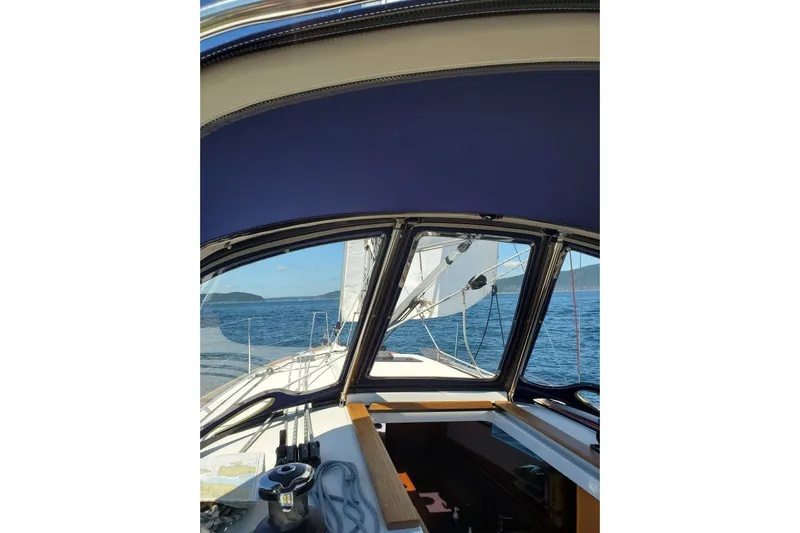 Imagine Yacht Photos Pics 2017 Jeanneau Sun Odyssey 349 sailing on open water, view from cockpit.