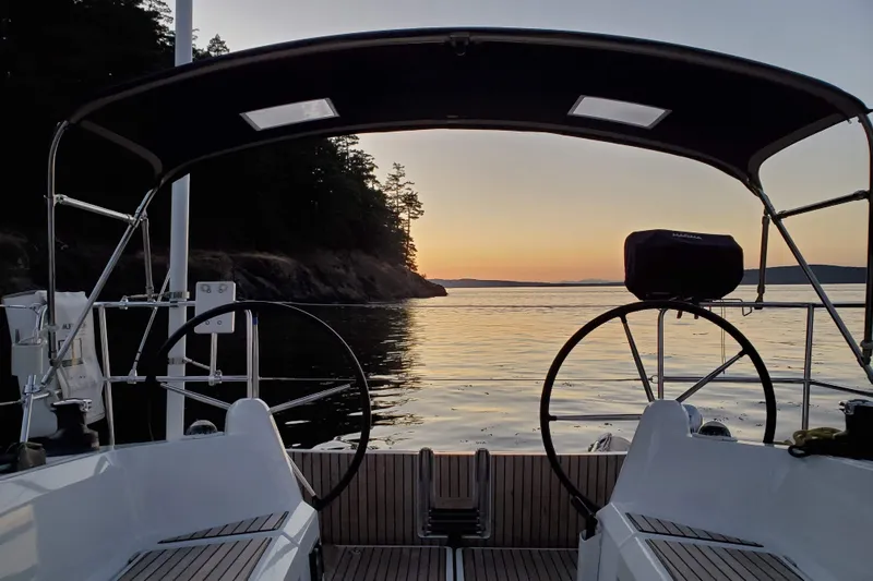 Imagine Yacht Photos Pics 2017 Jeanneau Sun Odyssey 349 sailboat at sunset, serene coastal view.