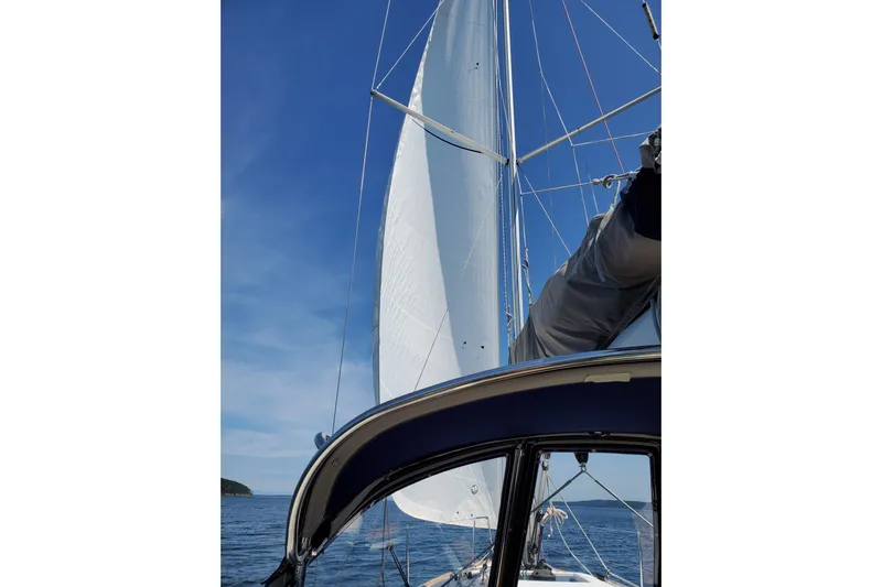 Imagine Yacht Photos Pics 2017 Jeanneau Sun Odyssey 349 sailboat with sails unfurled on a clear day.