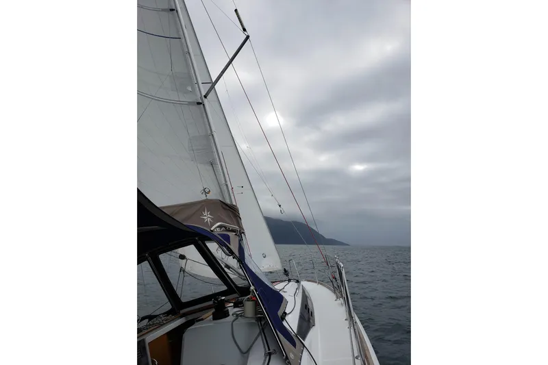 Imagine Yacht Photos Pics 2017 Jeanneau Sun Odyssey 349 sailing on a cloudy day, showcasing sails and deck.