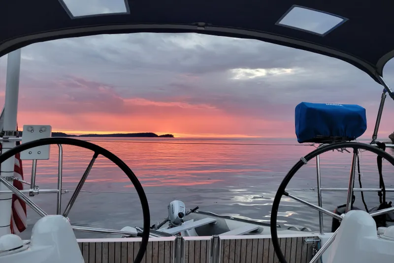 Imagine Yacht Photos Pics Jeanneau Sun Odyssey 349 sailboat at sunset, 2017 model, serene ocean view.
