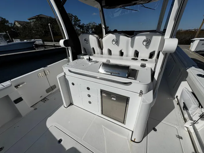 Bali Hai Yacht Photos Pics 2020 Edgewater 370CC boat interior with seating and built-in grill station.