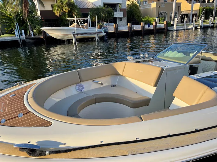 Grato Yacht Photos Pics 2015 Chris-Craft 32 Launch boat with elegant seating, docked by a waterfront.