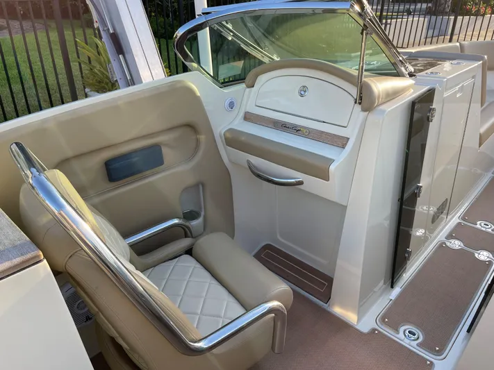 Grato Yacht Photos Pics Luxurious interior of a 2015 Chris-Craft 32 Launch boat with beige seating and sleek design.