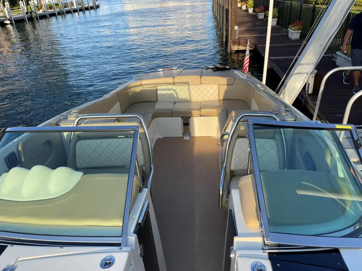 Grato Yacht Photos Pics 2015 Chris-Craft 32 Launch boat with spacious seating, docked by the water.