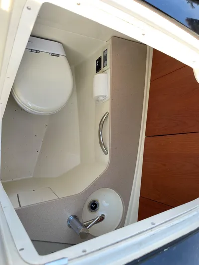 Grato Yacht Photos Pics 2015 Chris-Craft 32 Launch boat interior bathroom with toilet and sink.