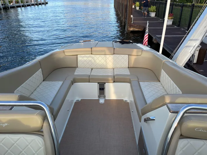 Grato Yacht Photos Pics 2015 Chris-Craft 32 Launch boat with elegant seating, docked by calm waters.