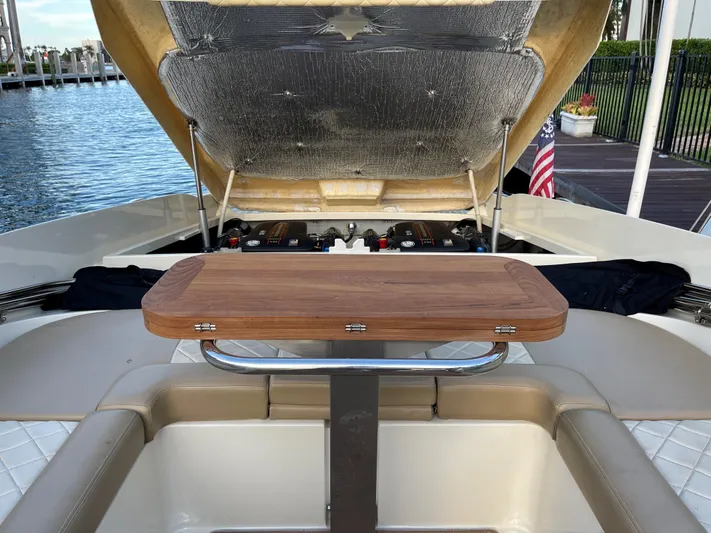 Grato Yacht Photos Pics 2015 Chris-Craft 32 Launch boat with open engine compartment and wooden table.
