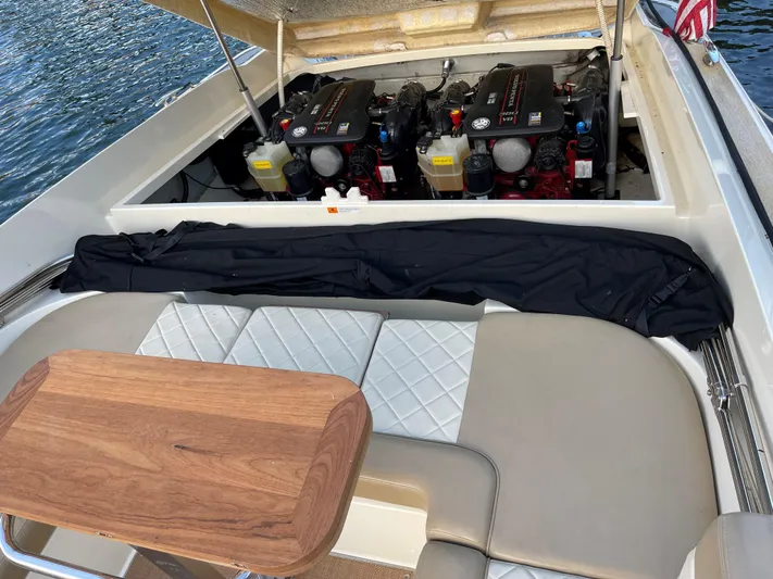 Grato Yacht Photos Pics 2015 Chris-Craft 32 Launch boat engine compartment with seating and wooden table.