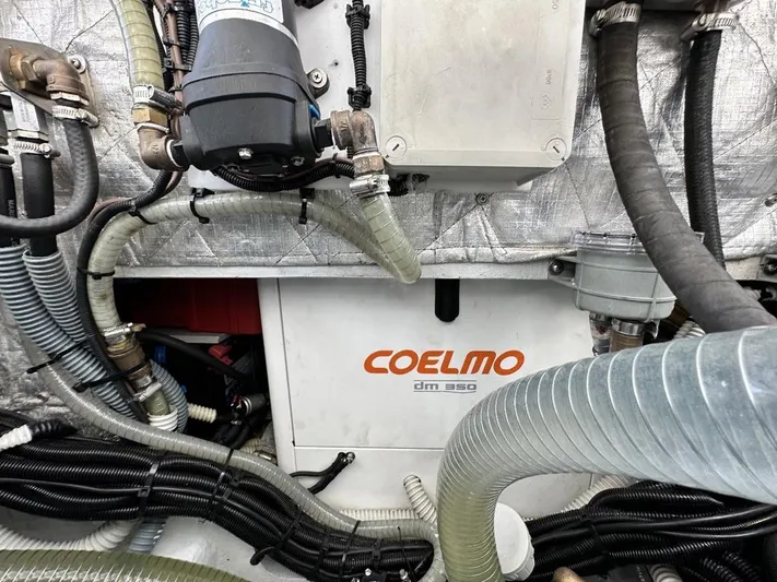  Yacht Photos Pics Engine room of 2006 Cranchi 48 Fly with Coelmo generator and various hoses.