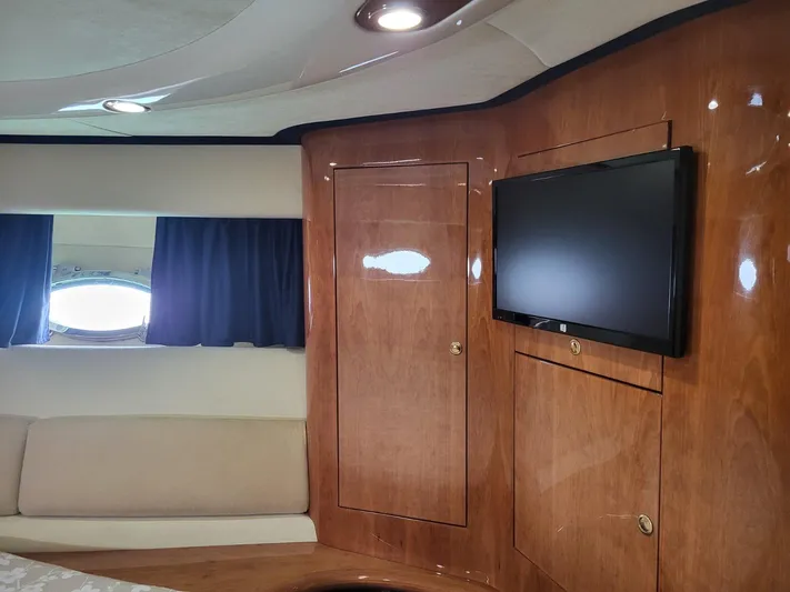  Yacht Photos Pics Interior of 2006 Cranchi 48 Fly yacht with wood paneling and mounted TV.
