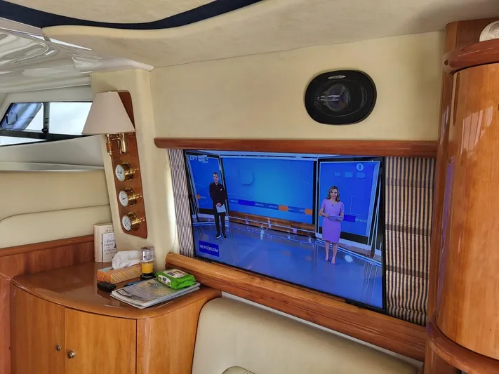  Yacht Photos Pics Interior of 2006 Cranchi 48 Fly yacht with TV and wooden cabinetry.