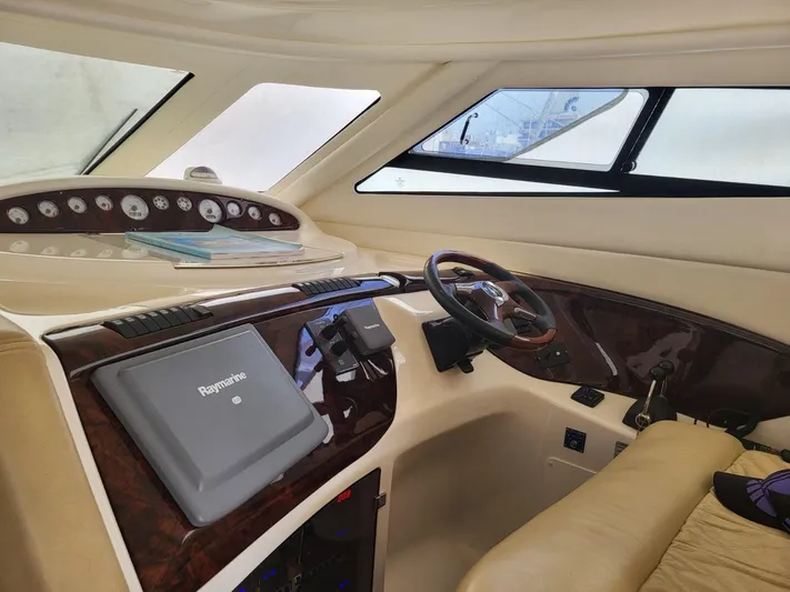  Yacht Photos Pics Interior cockpit of 2006 Cranchi 48 Fly yacht with navigation equipment and steering wheel.