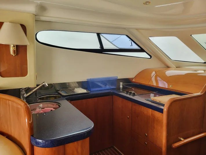  Yacht Photos Pics Interior of 2006 Cranchi 48 Fly yacht with modern kitchen and wooden cabinetry.