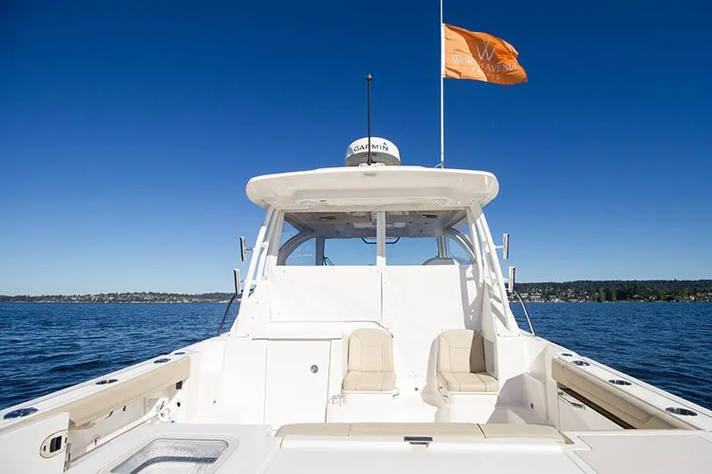 Lady Ann Name Reserved Yacht Photos Pics 2018 Pursuit OS 355 Offshore boat on calm water under clear blue sky.
