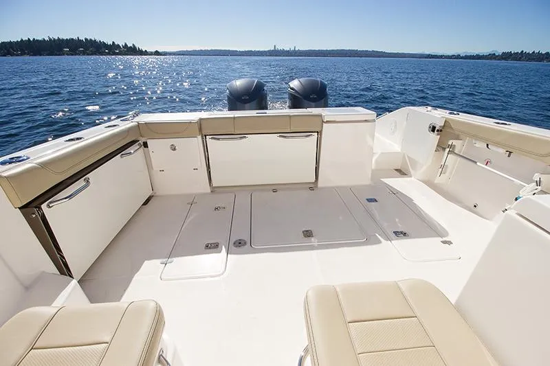 Lady Ann Name Reserved Yacht Photos Pics 2018 Pursuit OS 355 Offshore boat deck with twin engines on a sunny day.