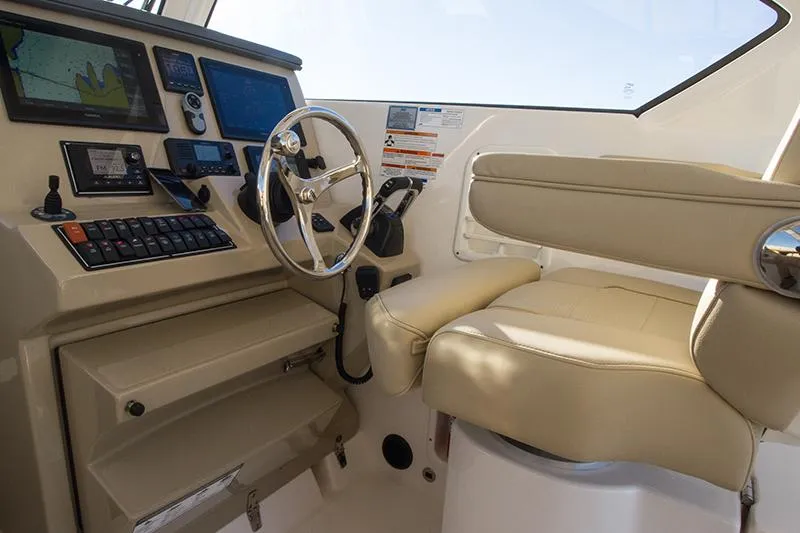 Lady Ann Name Reserved Yacht Photos Pics 2018 Pursuit OS 355 Offshore helm with navigation screens and beige seating.