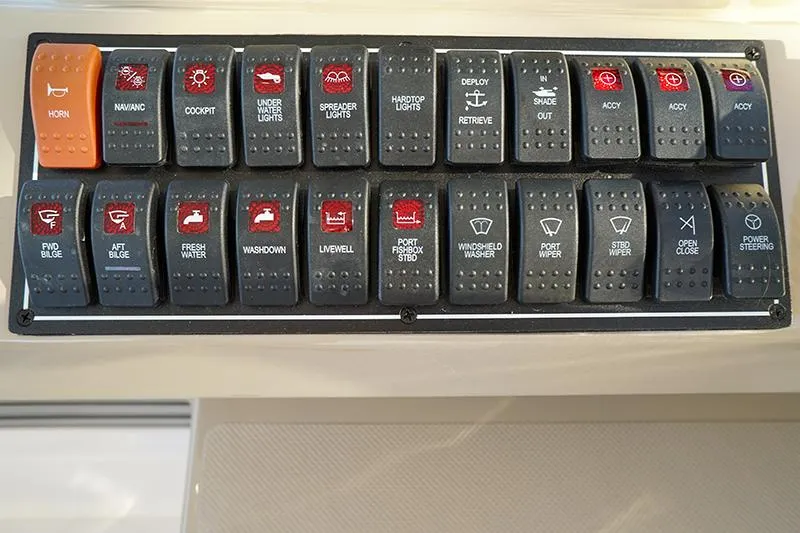 Lady Ann Name Reserved Yacht Photos Pics Control panel of a 2018 Pursuit OS 355 Offshore boat with labeled switches.
