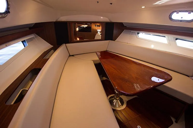 Lady Ann Name Reserved Yacht Photos Pics 2018 Pursuit OS 355 Offshore cabin with elegant seating and wooden table.