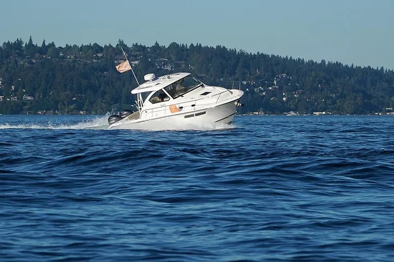 Lady Ann Name Reserved Yacht Photos Pics 2018 Pursuit OS 355 Offshore boat cruising on a scenic lake with forested hills.