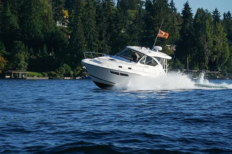Lady Ann Name Reserved Yacht Photos Pics 2018 Pursuit OS 355 Offshore cruising on a scenic lake with forested shoreline.