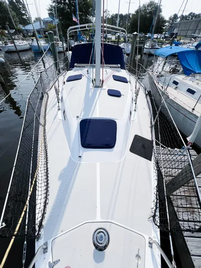 Cheers Yacht Photos Pics 2006 Catalina 350 sailboat deck view with blue cushions, docked in a marina.
