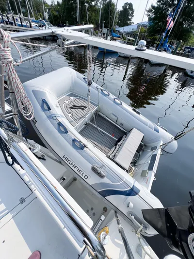 Cheers Yacht Photos Pics Inflatable boat docked beside a 2006 Catalina 350 sailboat in a marina.