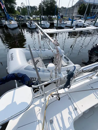 Cheers Yacht Photos Pics 2006 Catalina 350 sailboat docked with dinghy, surrounded by other boats in a marina.