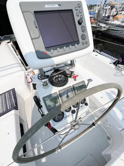 Cheers Yacht Photos Pics Steering wheel and navigation system on a 2006 Catalina 350 sailboat.