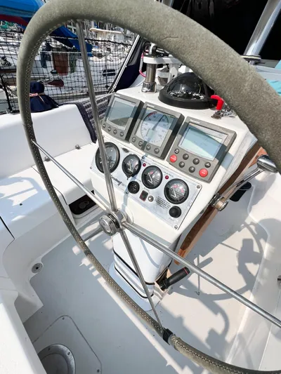 Cheers Yacht Photos Pics Steering wheel and control panel of a 2006 Catalina 350 sailboat cockpit.
