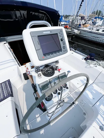 Cheers Yacht Photos Pics Steering wheel and navigation system on a 2006 Catalina 350 sailboat.