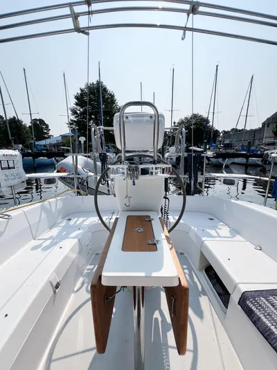 Cheers Yacht Photos Pics 2006 Catalina 350 sailboat cockpit with steering wheel and seating, docked at marina.