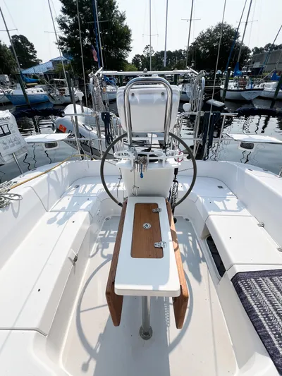 Cheers Yacht Photos Pics 2006 Catalina 350 sailboat cockpit with steering wheel and seating, docked at a marina.
