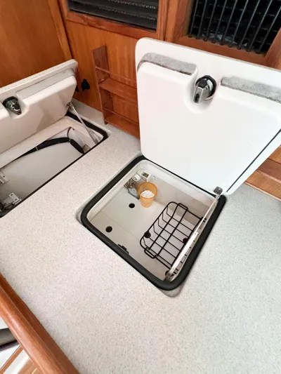 Cheers Yacht Photos Pics Open storage compartments in a 2006 Catalina 350 yacht interior.