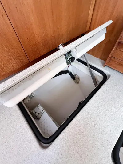 Cheers Yacht Photos Pics Open storage compartment in 2006 Catalina 350 sailboat interior.