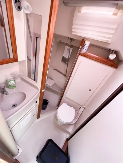 Cheers Yacht Photos Pics 2006 Catalina 350 yacht bathroom with sink, toilet, and storage.