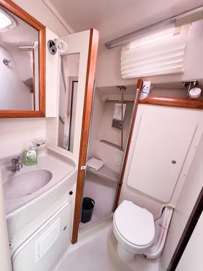 Cheers Yacht Photos Pics 2006 Catalina 350 yacht bathroom with sink, toilet, and shower.