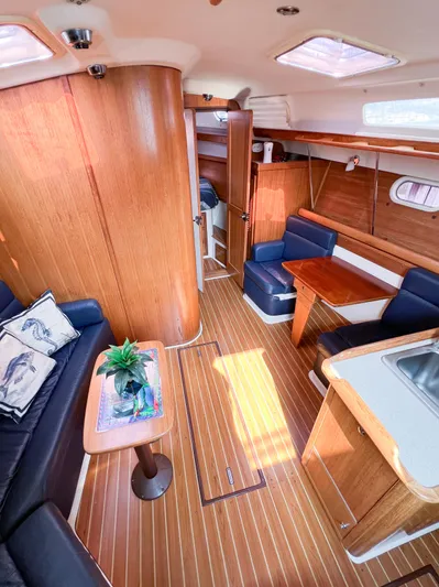 Cheers Yacht Photos Pics Interior of a 2006 Catalina 350 sailboat with wood finish and cozy seating area.