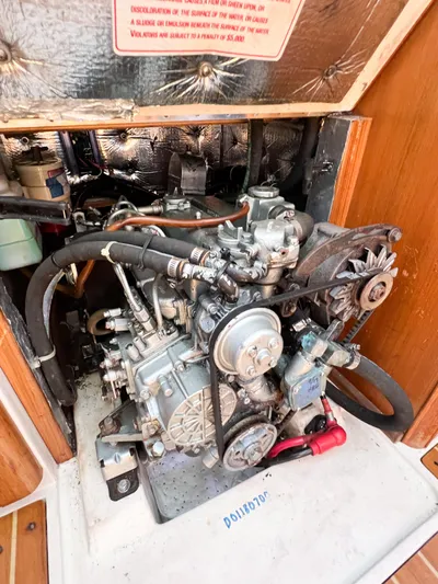 Cheers Yacht Photos Pics Engine compartment of a 2006 Catalina 350 sailboat, showcasing mechanical components and wiring.