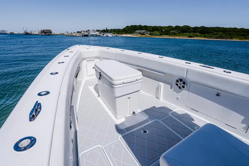 Fear N Money Yacht Photos Pics 2019 Concept 392 ProFish boat deck with seating and storage, near a scenic shoreline.