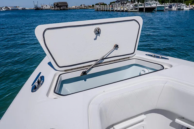 Fear N Money Yacht Photos Pics Open storage compartment on 2019 Concept 392 ProFish boat, docked in a marina.