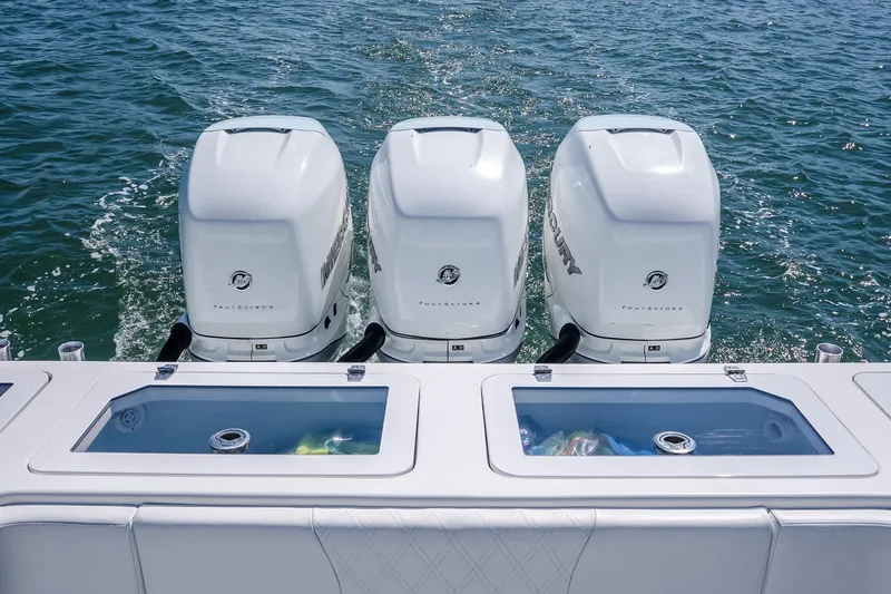 Fear N Money Yacht Photos Pics Triple outboard engines on 2019 Concept 392 ProFish boat, ocean backdrop.
