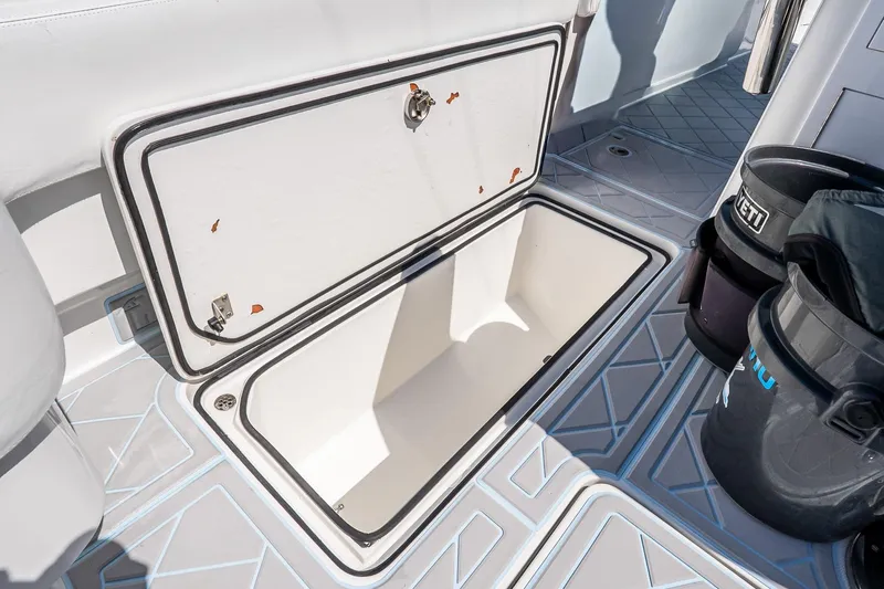 Fear N Money Yacht Photos Pics Open storage compartment on 2019 Concept 392 ProFish boat deck, with Yeti buckets nearby.